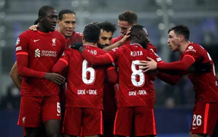 Liverpool Team in Red Celebrate Goal